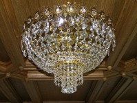 Surface-mounted basket crystal chandelier with crystal stones on wooden ceiling