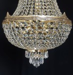 The lower half of a large basket chandelier made of cast brass