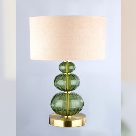 Une lampe de table discrète en verre vert foncé de la couleur d'une étoile tombée (Moldavite).