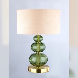 Une lampe de table discrète en verre vert foncé de la couleur d'une étoile tombée (Moldavite).