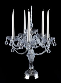 large crystal candlestick on a table made of silver metal and crystal glass